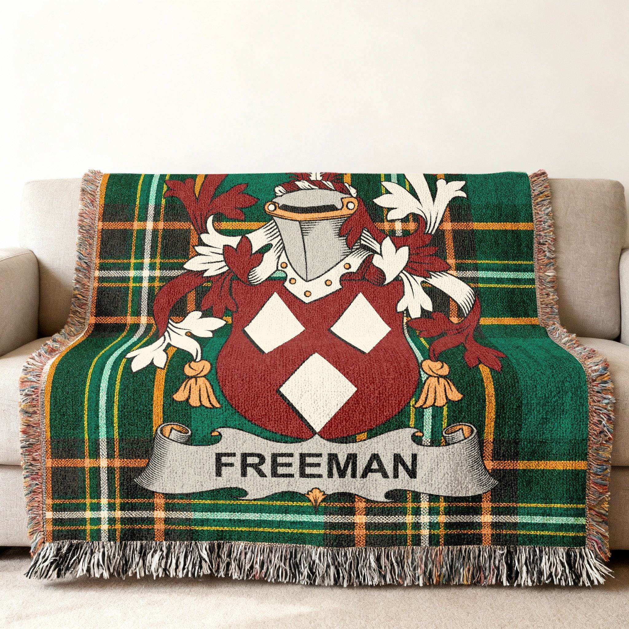 Woven throw blanket with green plaid and the Freeman family crest.