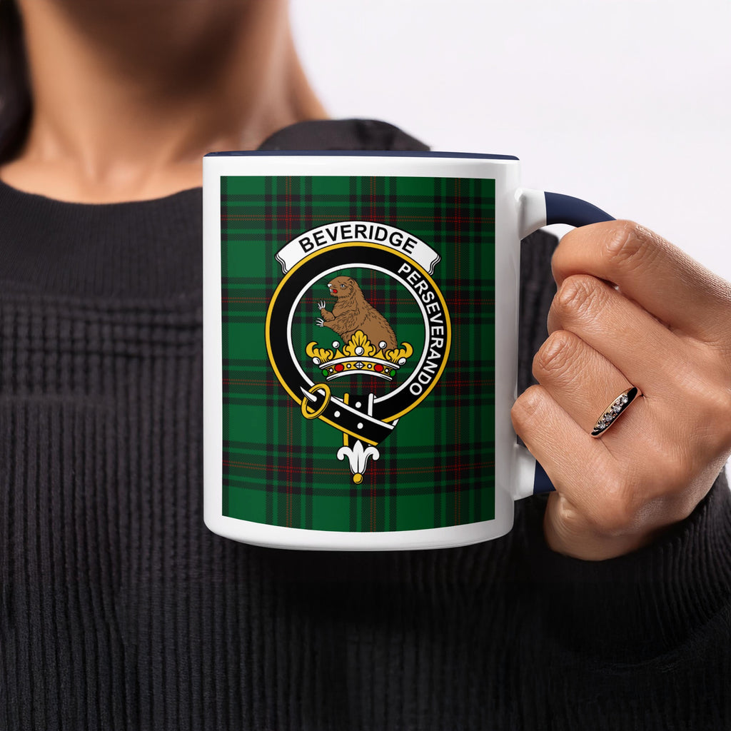 Close-up lifestyle view of Beveridge Scottish family crest artwork on a navy 11 oz accent mug with a tartan background