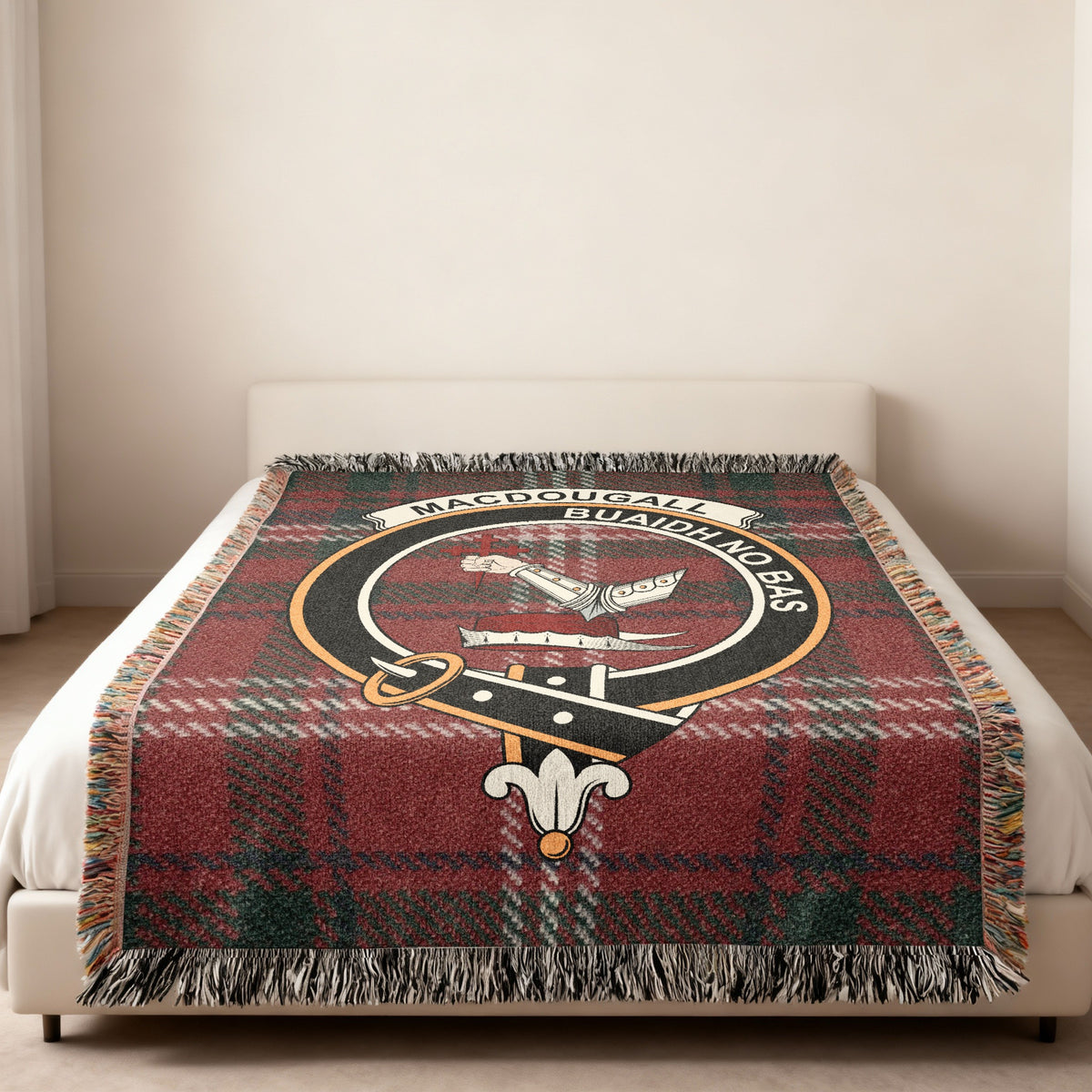 MacDougall Scottish woven blanket spread across a bed, showing the full crest design and tartan background