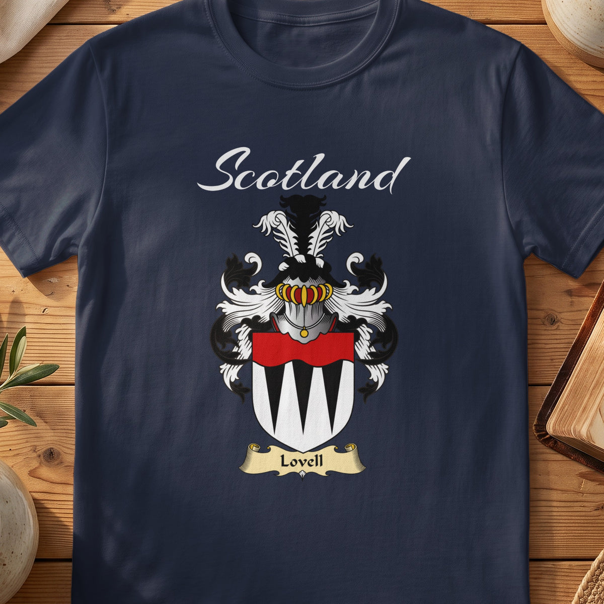 Navy Lovell family shield T-shirt featuring a black-and-white pointed pattern beneath a red band