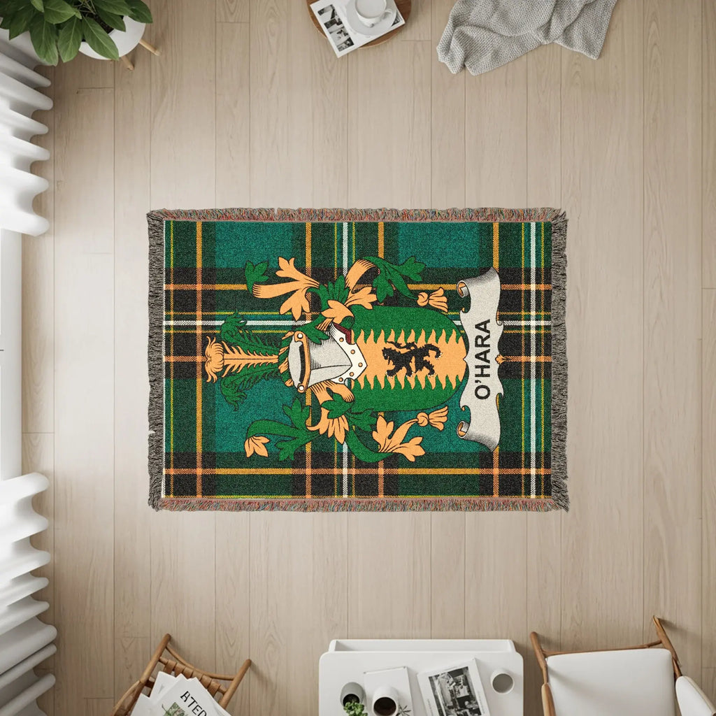 Woven blanket featuring O'Hara family crest on green and brown plaid.