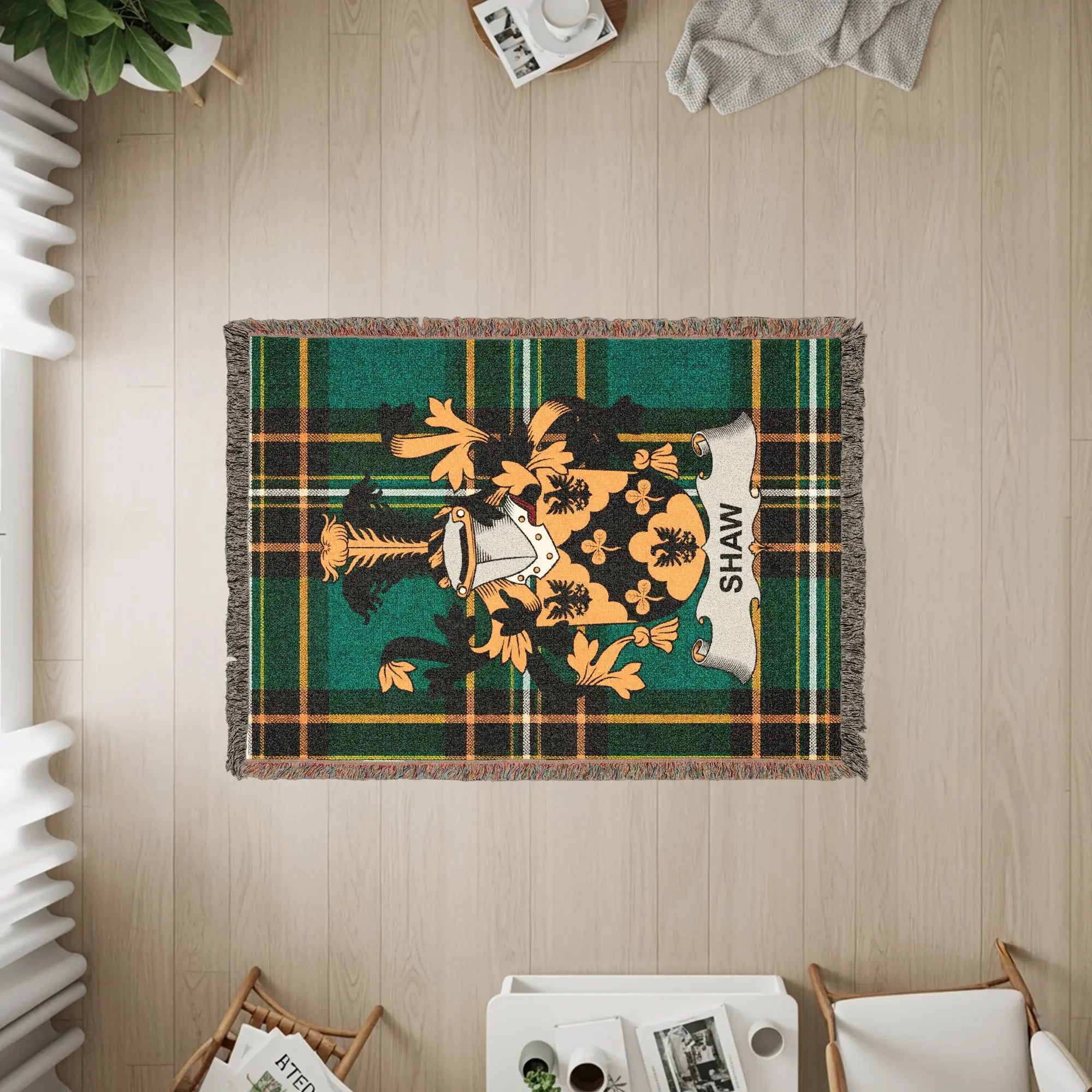 Shaw family crest on green and black plaid throw blanket.