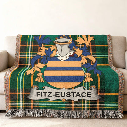 Fitz-Eustace family crest on a green plaid woven throw blanket.