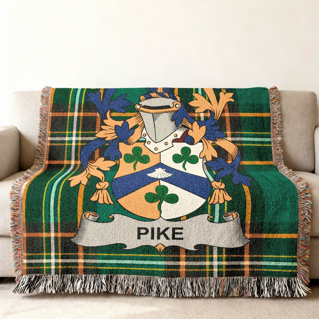 Pike family crest on a green tartan woven throw blanket.
