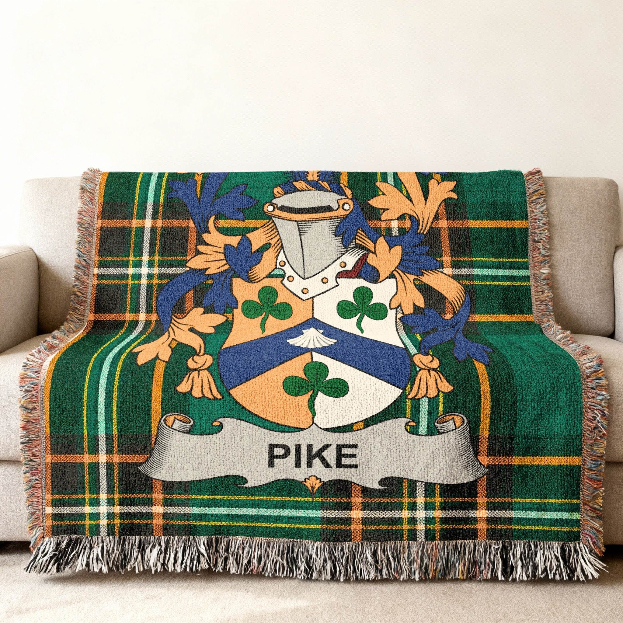 Pike family crest on a green tartan woven throw blanket.