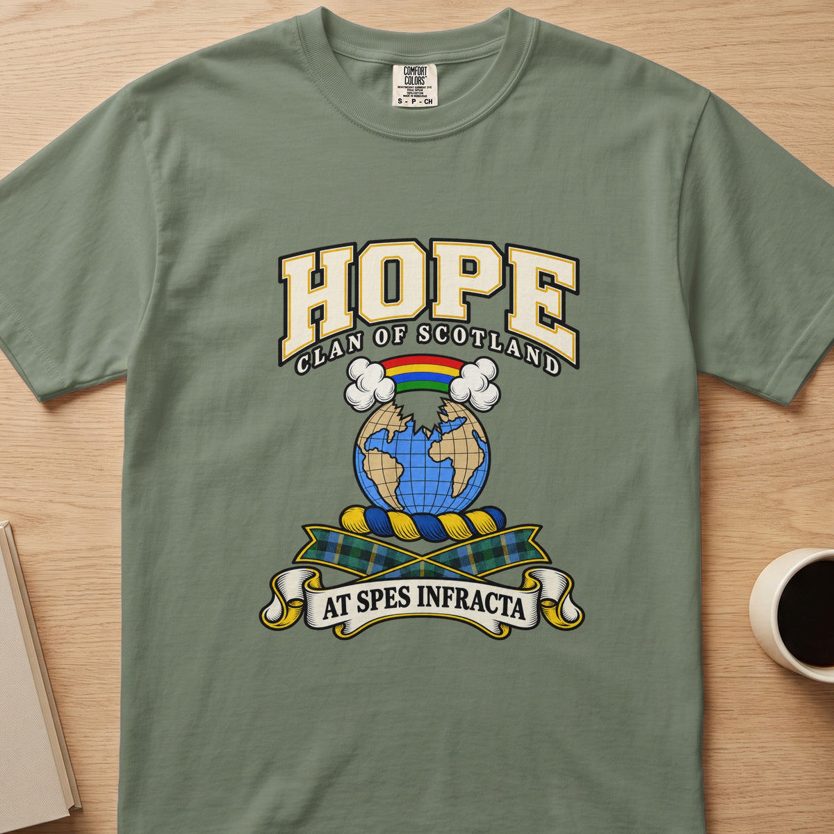 Hope clan crest with globe and rainbow on a sage green Comfort Colors T-shirt, front view