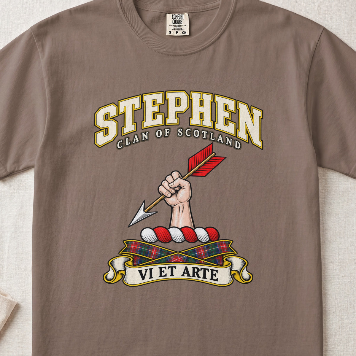 Stephen Scottish clan T-shirt in Espresso, front view with a hand holding an arrow with red feathers and motto design.