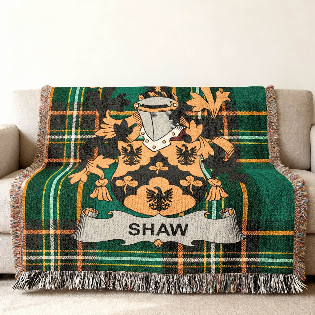 Woven blanket featuring a Scottish crest with the name "SHAW" on a tartan background.