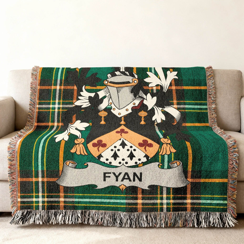 Green plaid blanket with FYAN family crest draped over a couch.