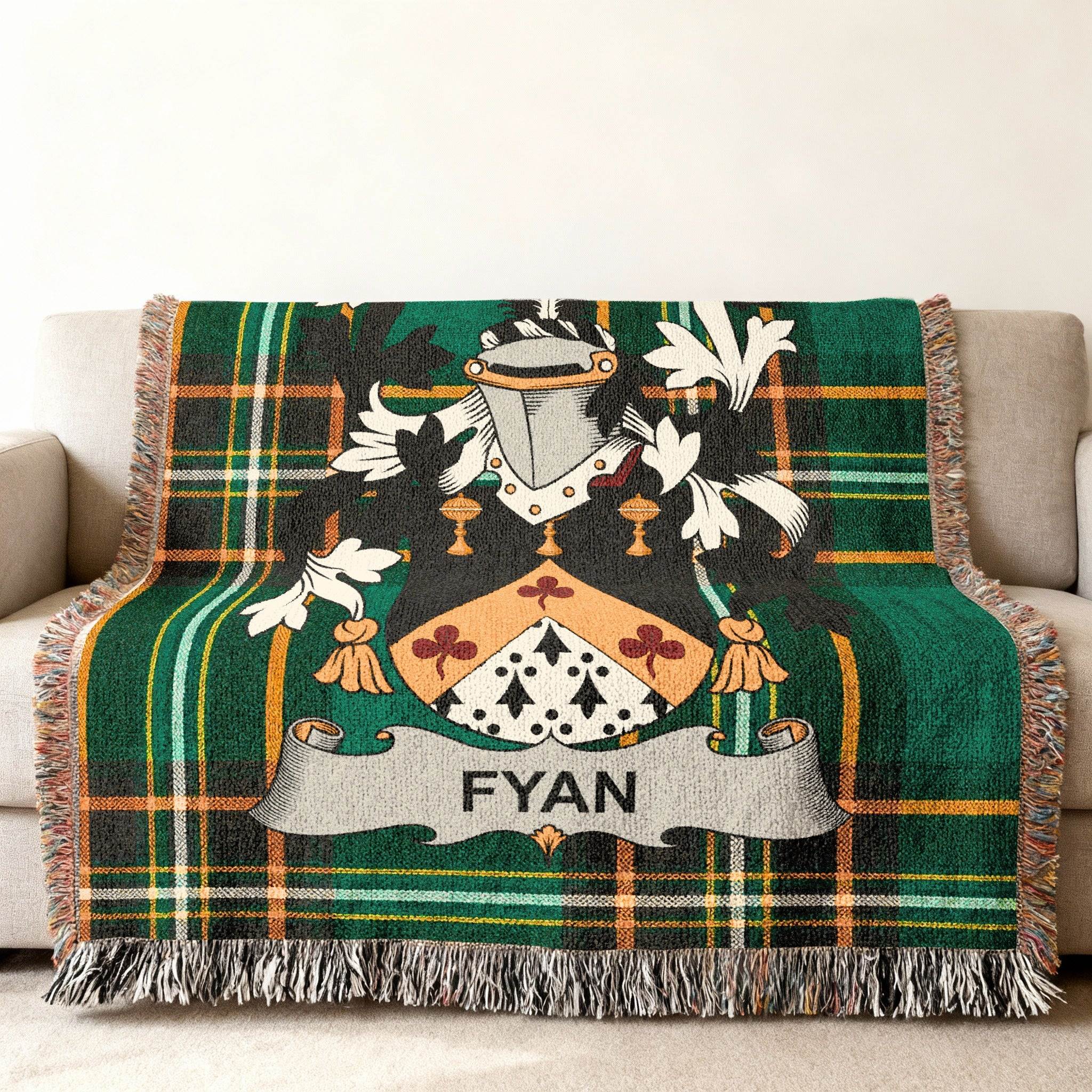 Green plaid blanket with FYAN family crest draped over a couch.