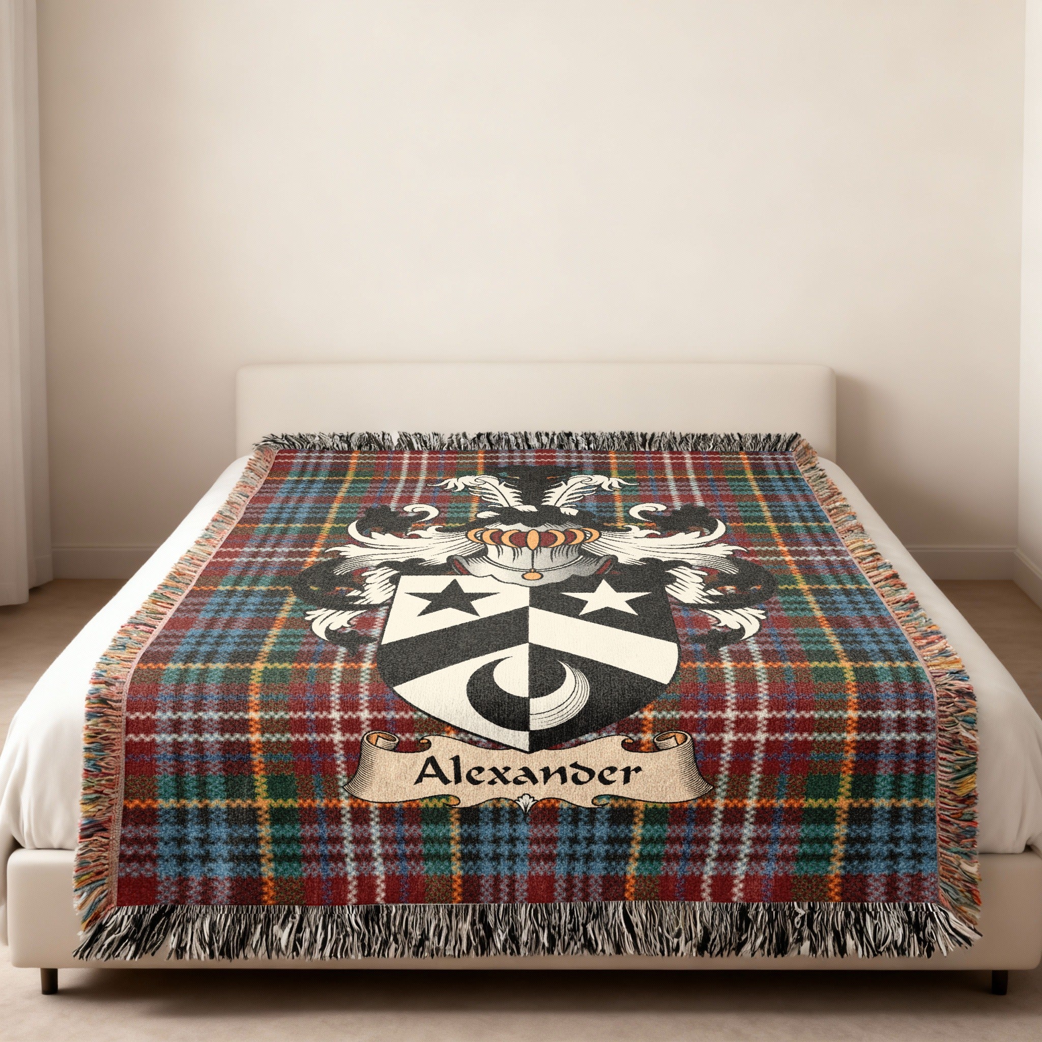 Alexander family crest emblem on a Caledonia tartan woven blanket