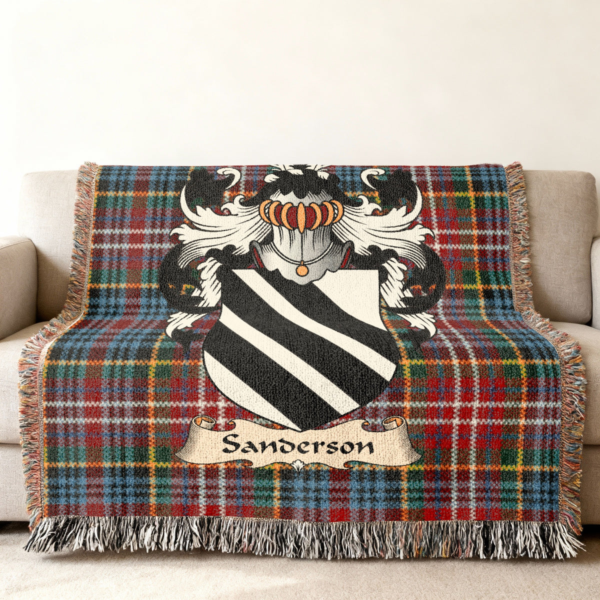Sanderson Scottish family shield woven blanket on a Caledonia tartan background