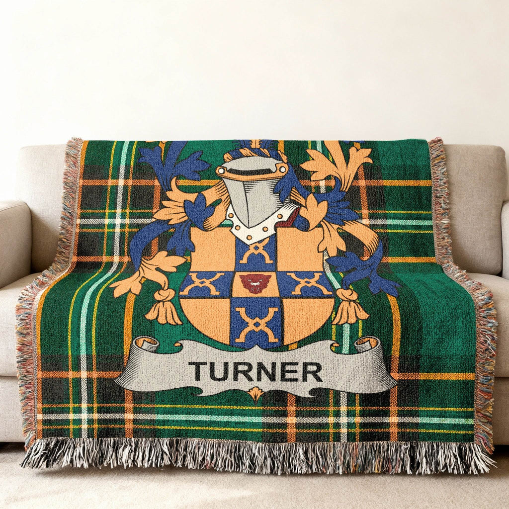 Turner family crest displayed on a green plaid woven throw blanket.