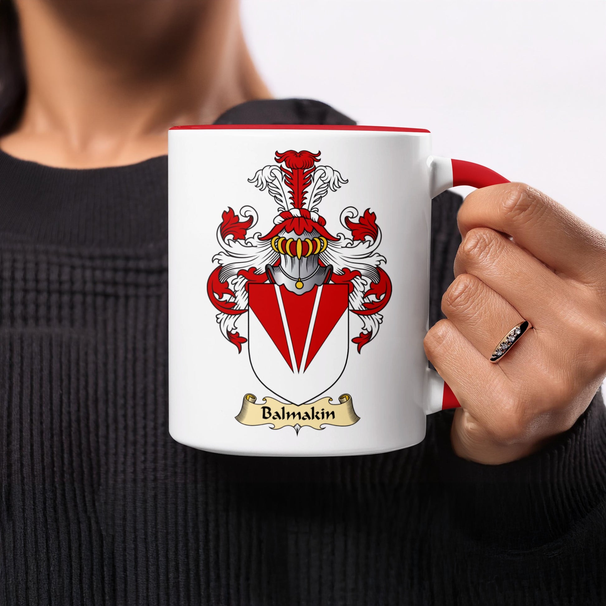 White mug with red rim and handle, displaying a coat of arms with the name Balmkin.