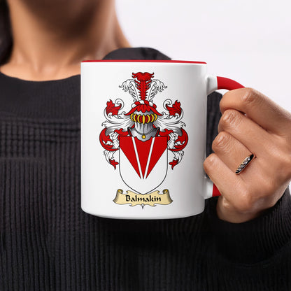 White mug with red rim and handle, displaying a coat of arms with the name Balmkin.