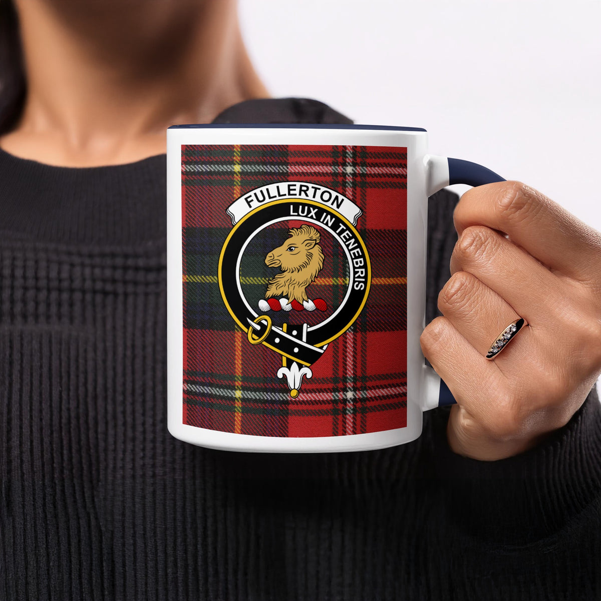 Close-up lifestyle view of Fullerton Scottish family crest artwork on a navy 11 oz accent mug with a tartan background