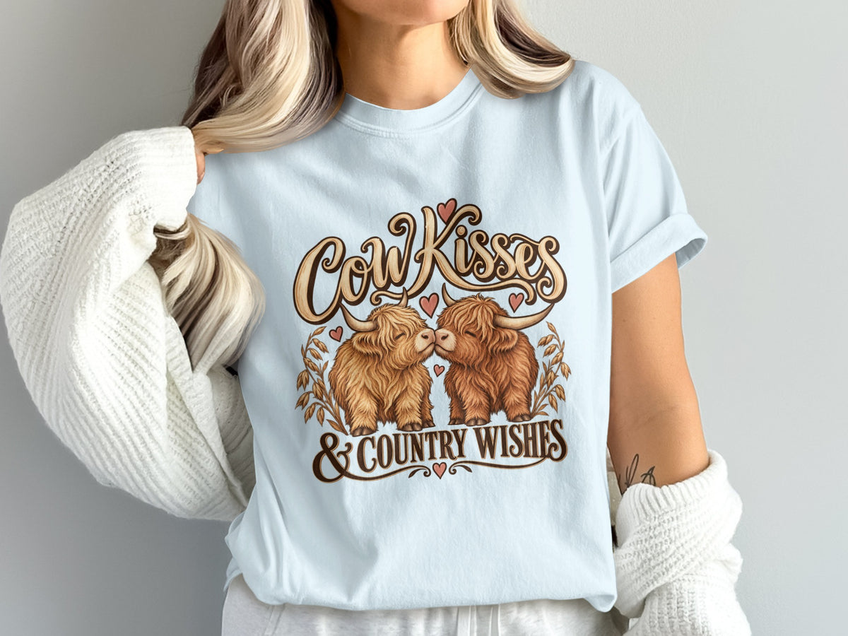 Model wearing the Cow Kisses & Country Wishes Highland cow Comfort Colors T-shirt in Chambray