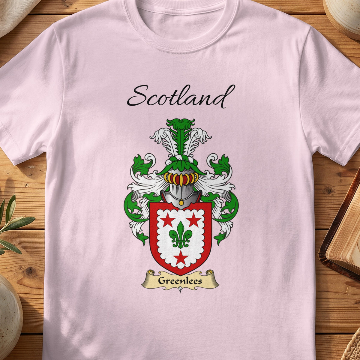 Light Pink Greenlees Scottish family shield T-shirt featuring a green fleur-de-lis within a red border