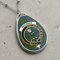 Oval pendant necklace featuring MacInnes tartan and crest with motto.