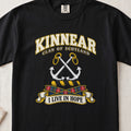 Kinnear Scottish clan T-shirt in Black, front view with crossed silver anchors and motto design.
