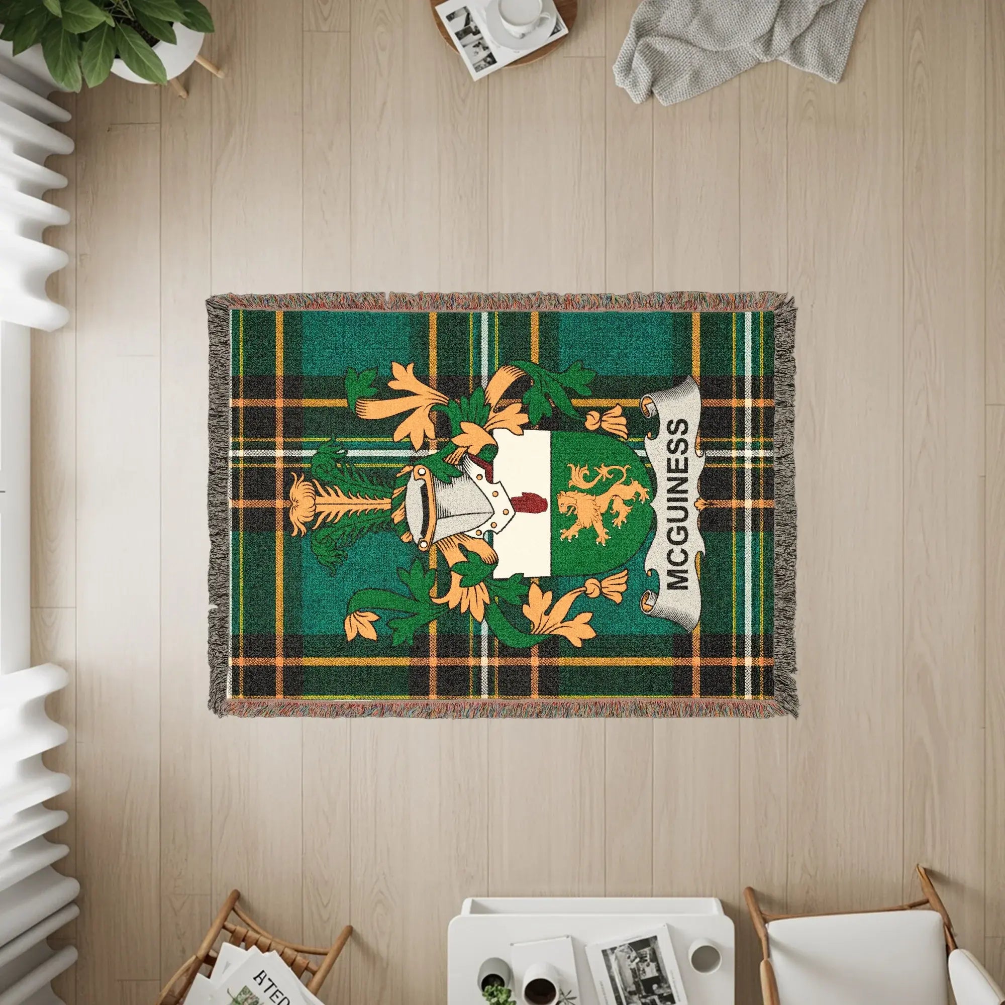 Green tartan woven blanket featuring the McGuinness family crest.