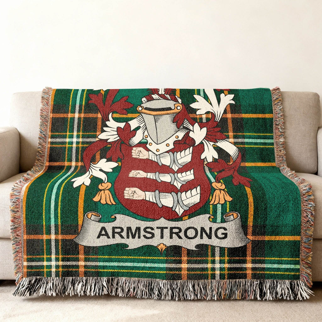 Armstrong coat of arms woven into Irish tartan blanket — green and gold fringe-edged heritage throw