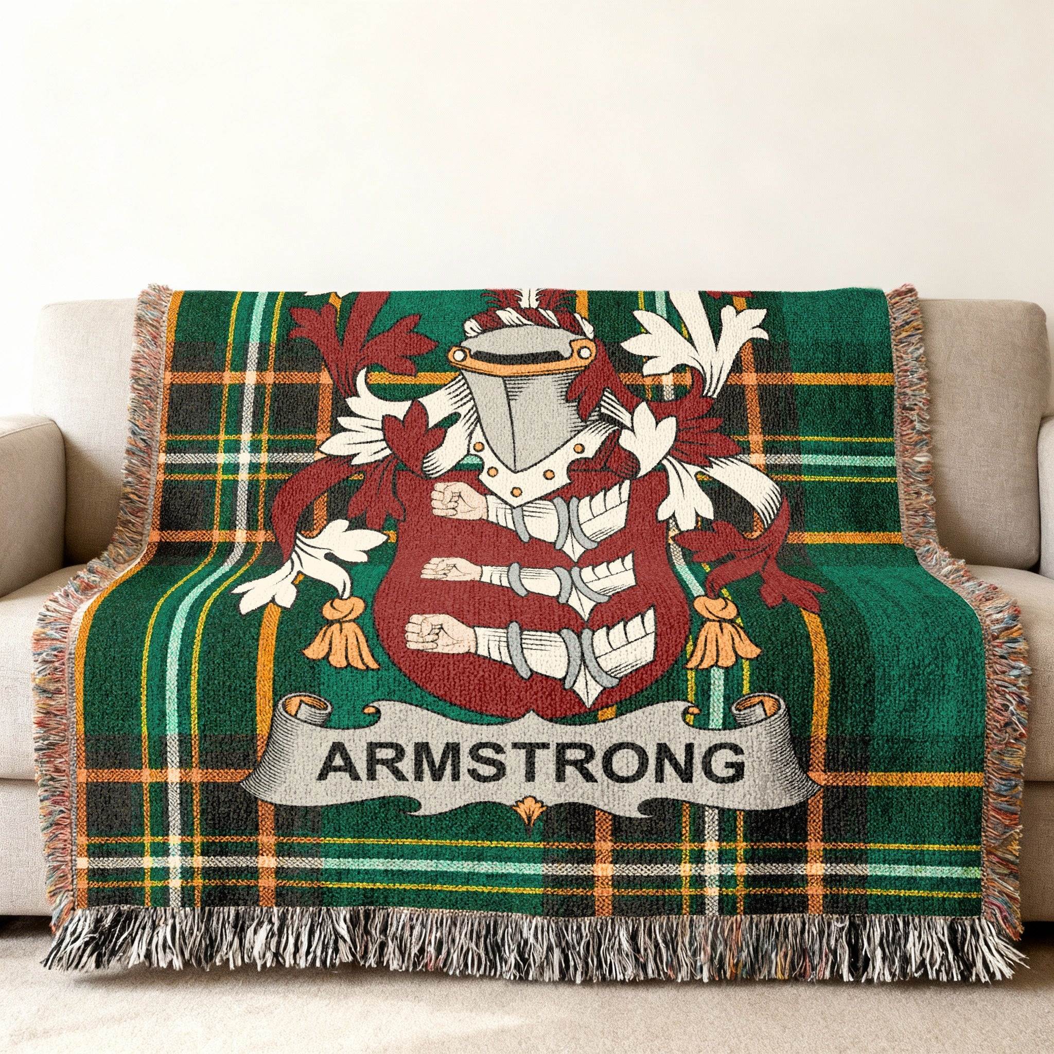 Armstrong coat of arms woven into Irish tartan blanket — green and gold fringe-edged heritage throw