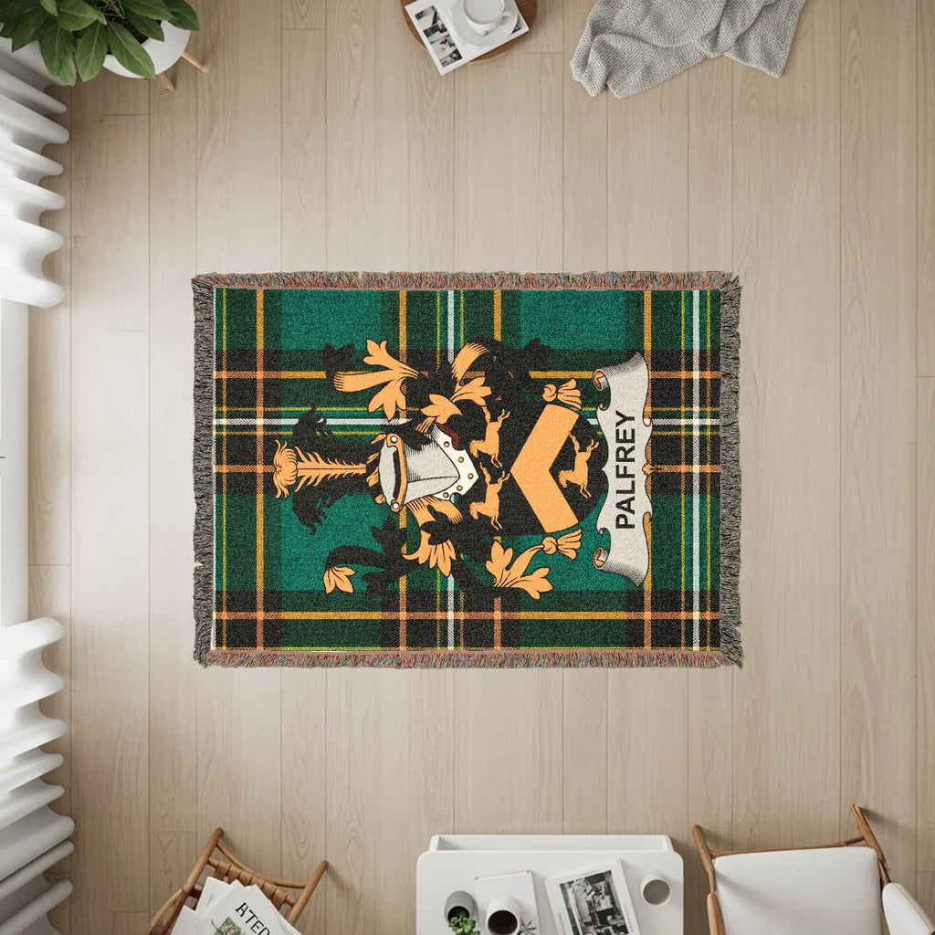 Palfrey tartan throw blanket with crest, displayed on a wooden floor.
