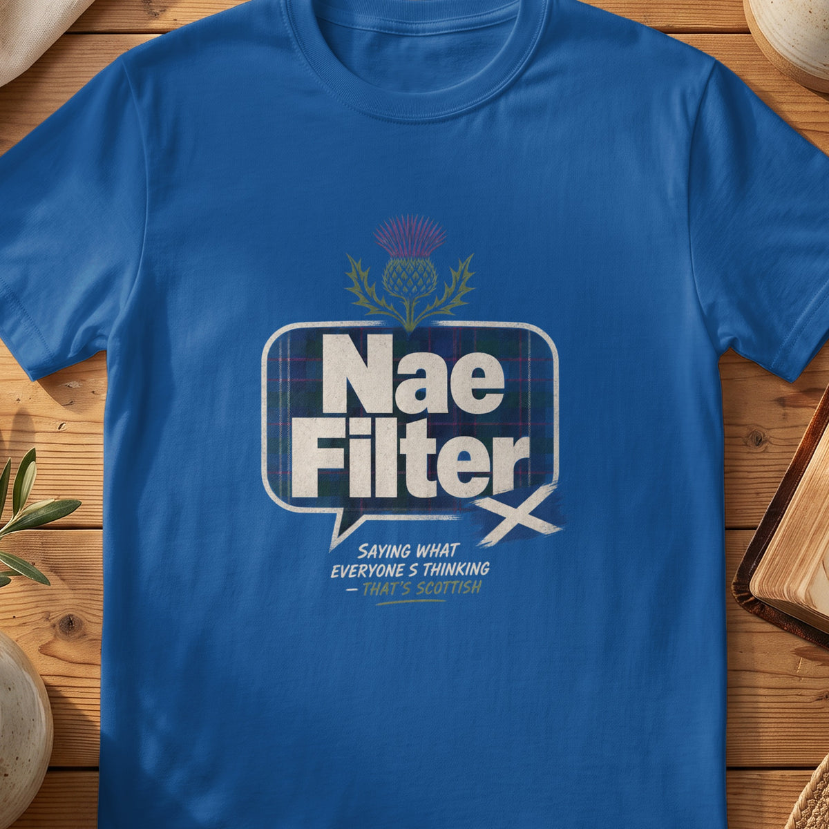 Blue t-shirt with "Nae Filter" text and a thistle graphic.