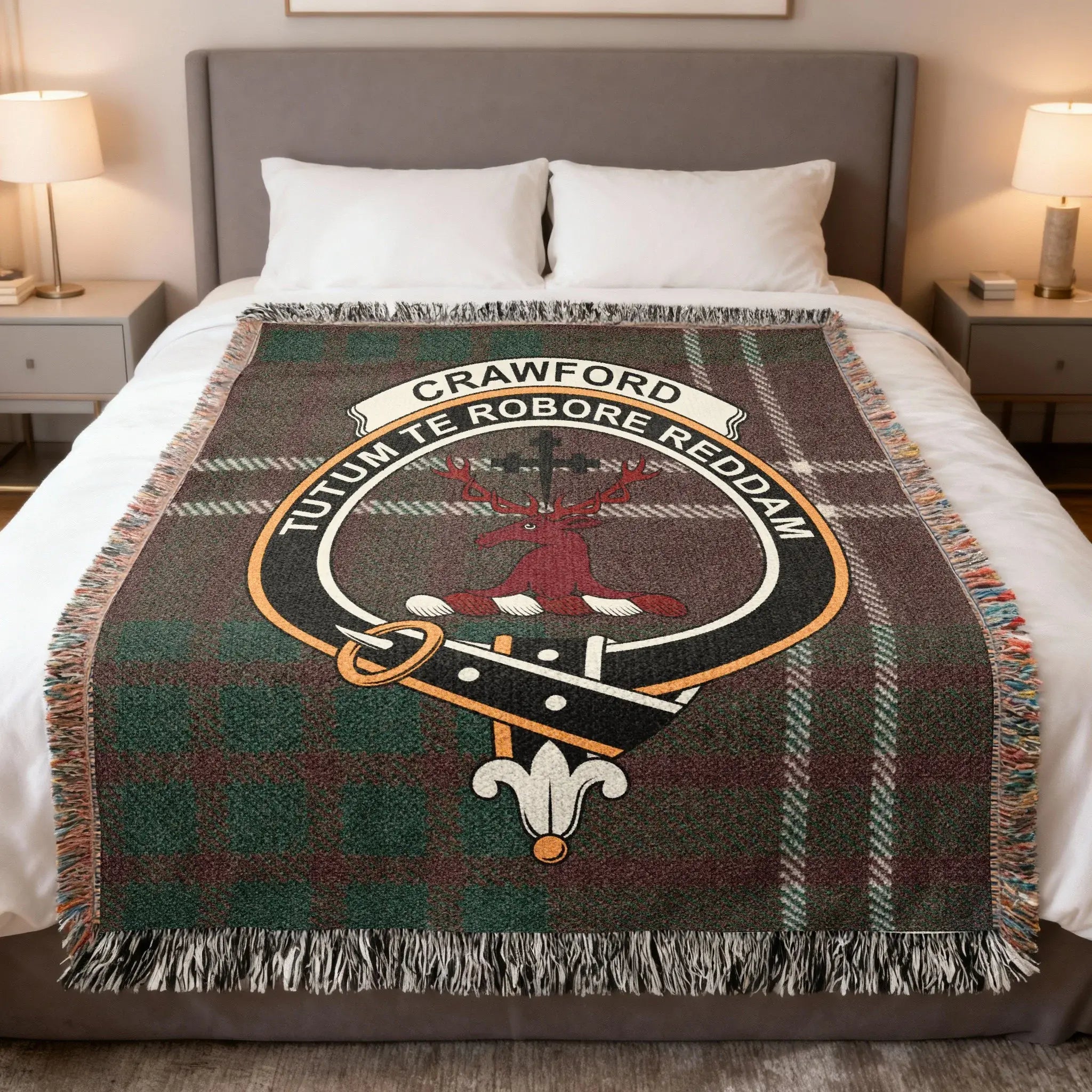 Crawford clan tartan woven blanket on sofa — 100% cotton with red-green stag crest design