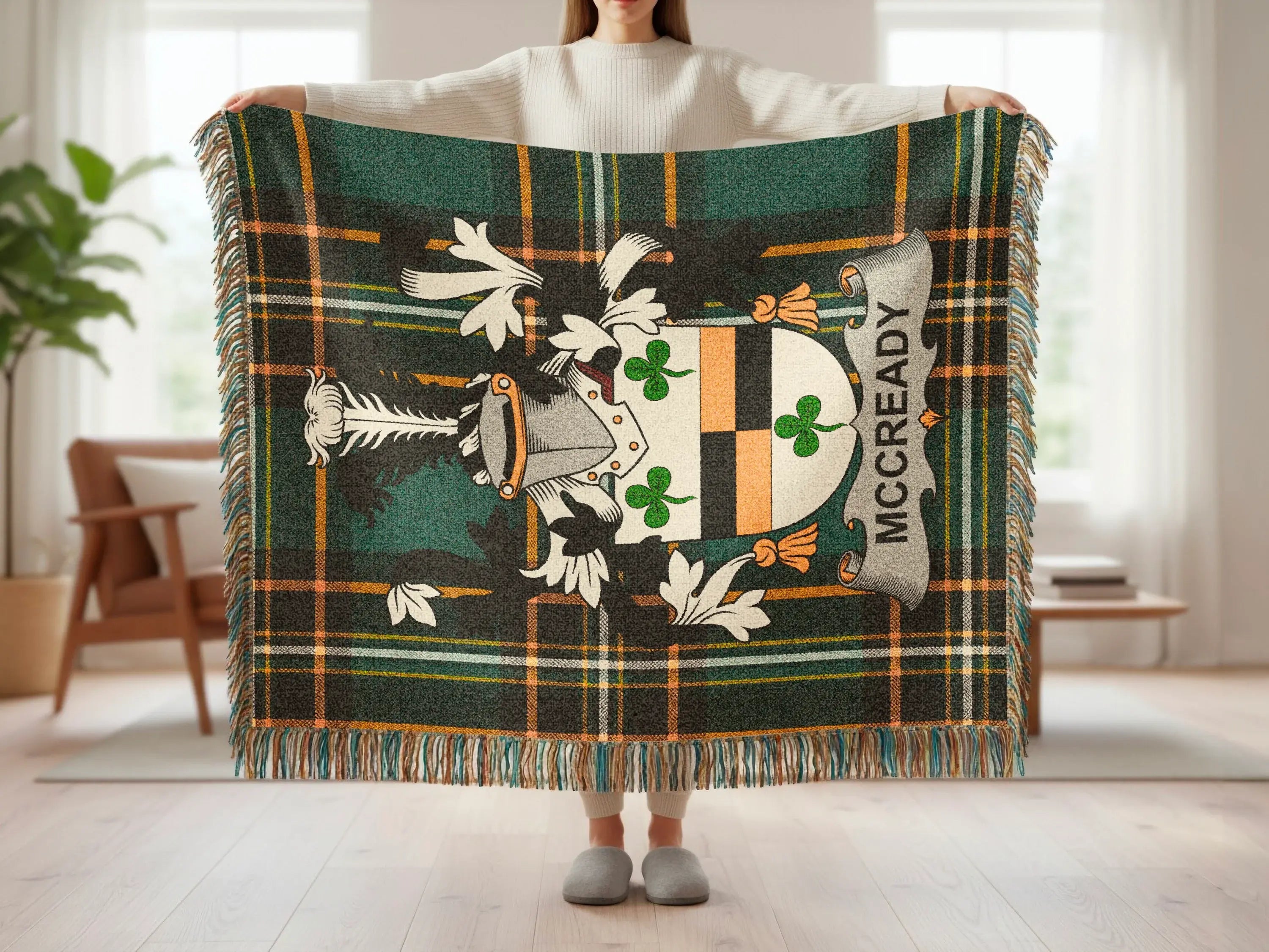 Tartan blanket with a grey and white coat of arms featuring "MCCREADY" in text.