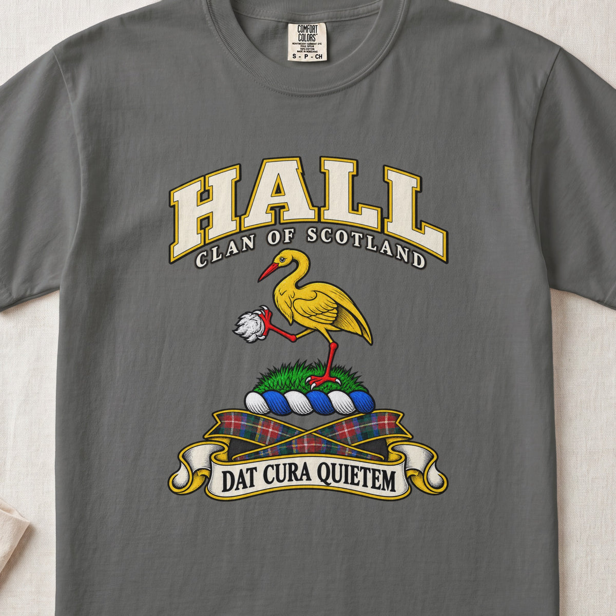 Hall Scottish clan T-shirt in Pepper, front view with a golden crane holding a white stone and motto banner.