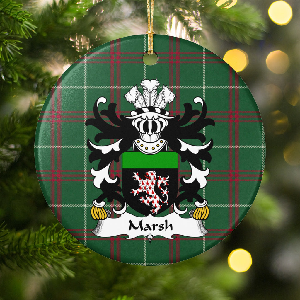 Marsh ornament hanging among Christmas tree branches and warm lights, with a red-and-white patterned lion on a black shield with a green top band on Welsh National Tartan.