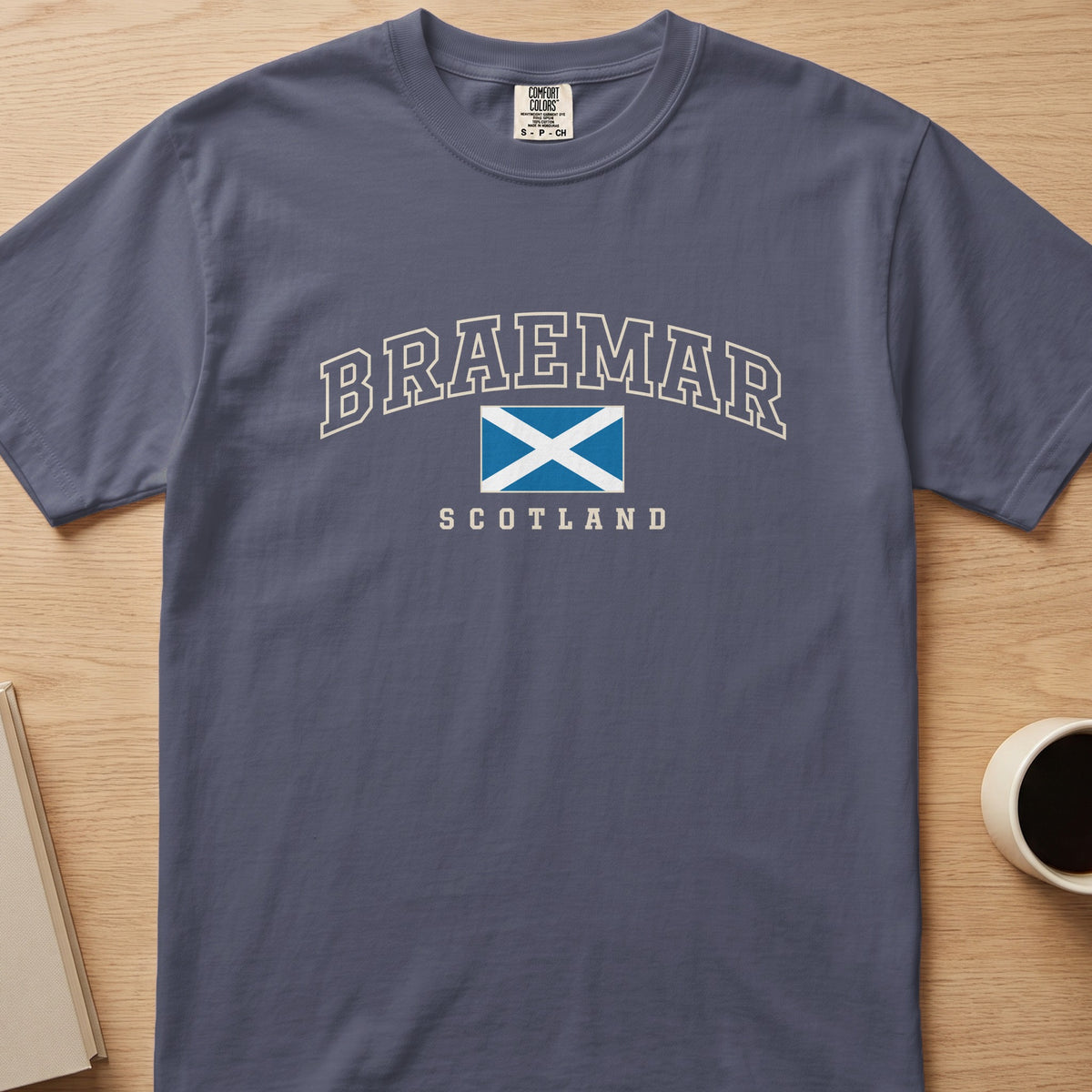 Denim Comfort Colors T-shirt laid flat with Braemar, Scotland lettering and a blue-and-white Saltire