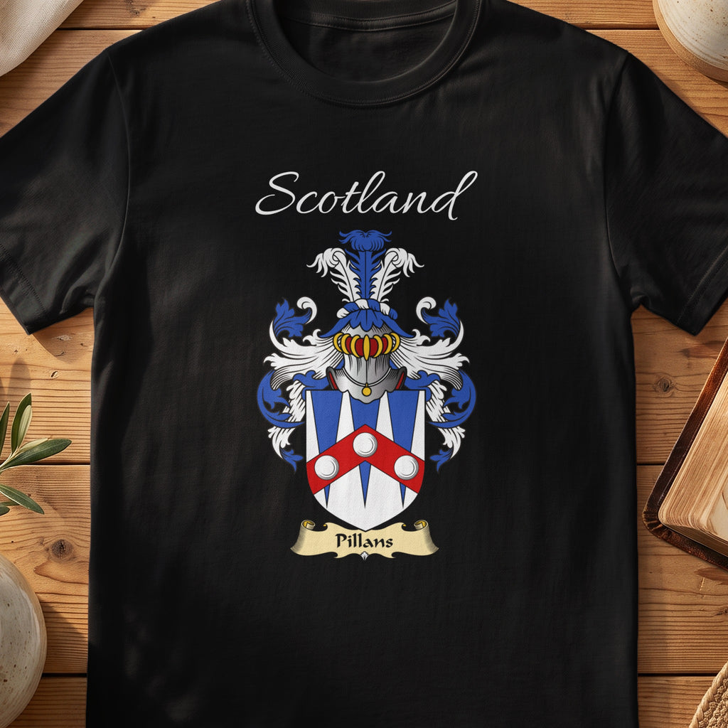 Black Pillans Scottish family crest T-shirt laid flat, showing “Scotland” above a blue-red-and-silver shield arranged around circular panels.