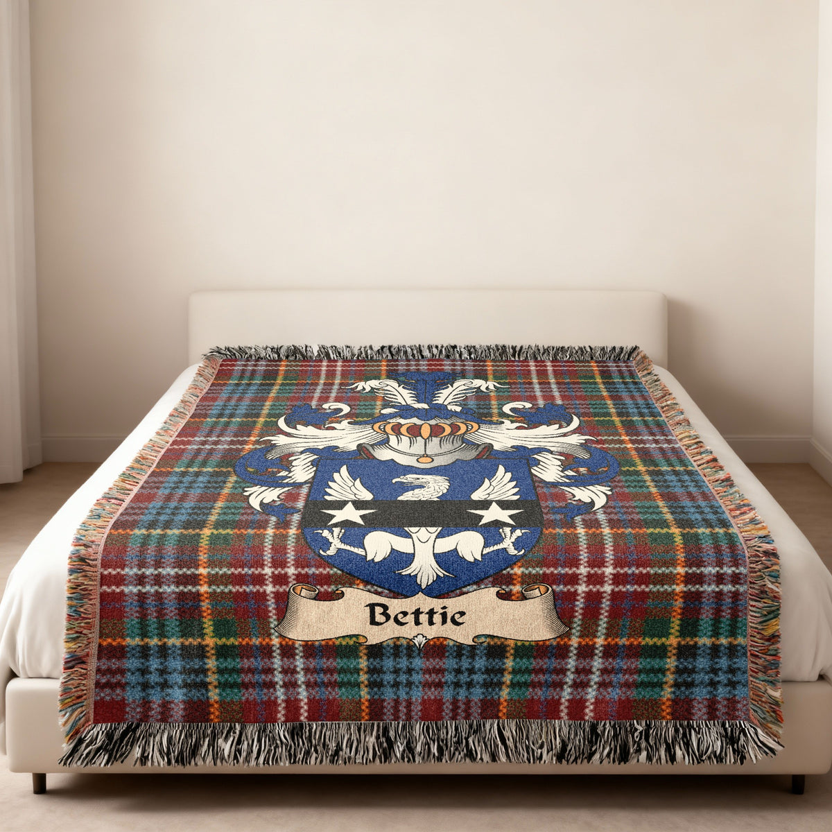 Bettie family crest emblem on a Caledonia tartan woven blanket
