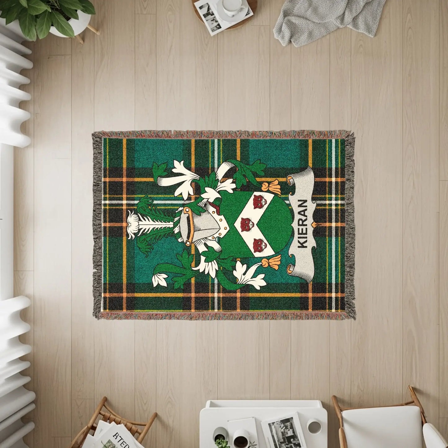 Kieran tartan woven blanket with family crest on wooden floor.