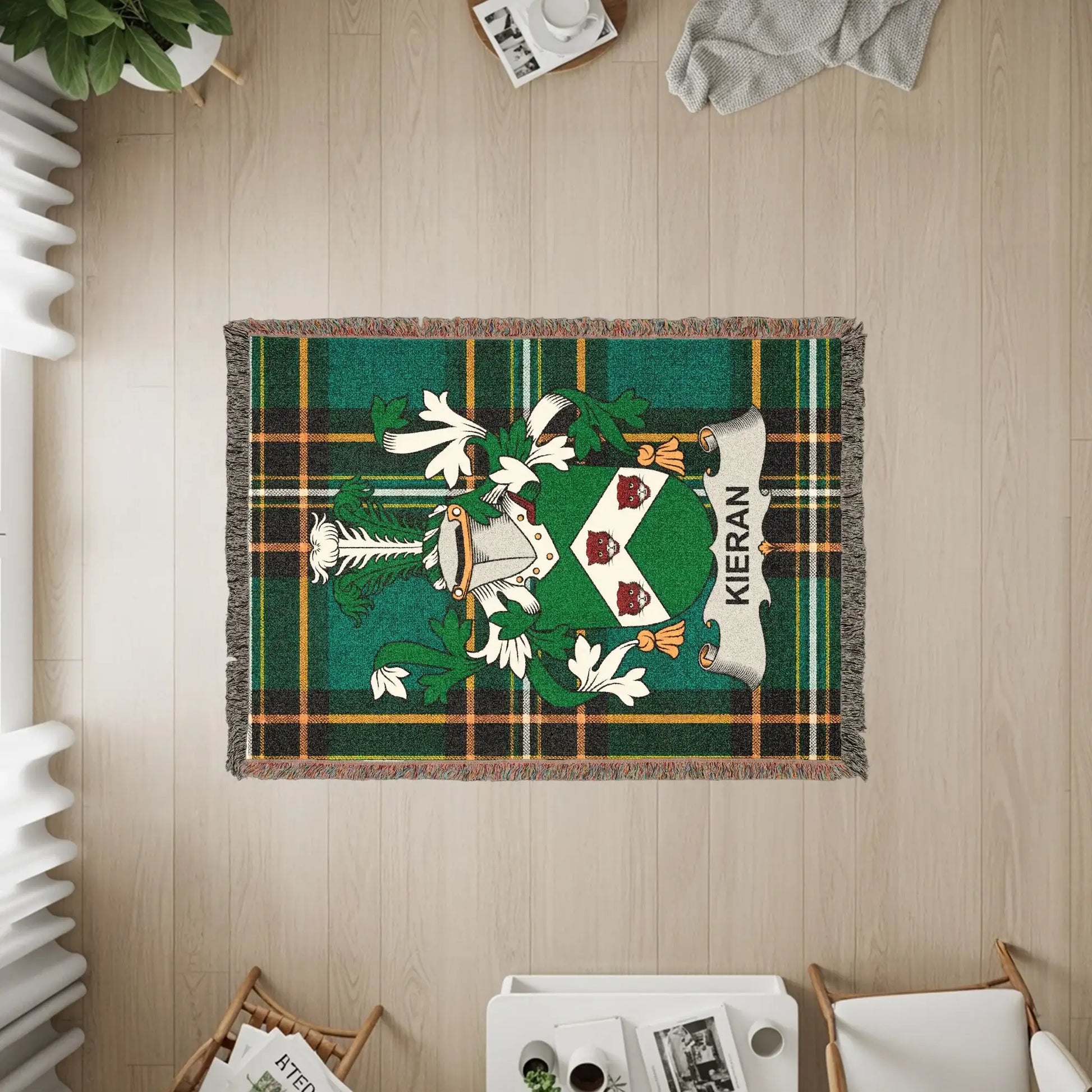 Kieran tartan woven blanket with family crest on wooden floor.