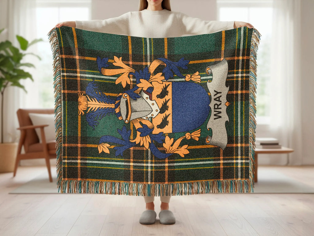 Tartan blanket with Wray crest, held up by a person.