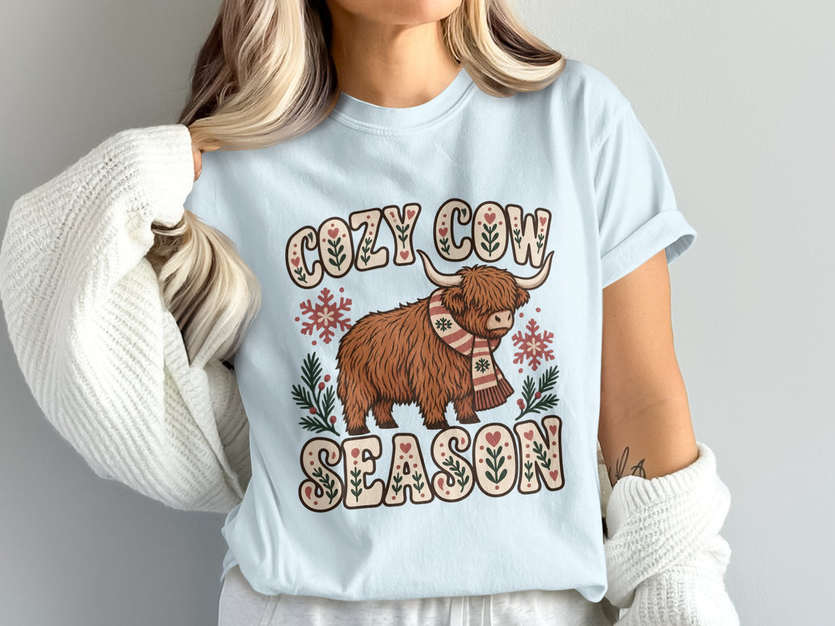 Model wearing the Cozy Cow Season Highland cow Comfort Colors T-shirt in Chambray