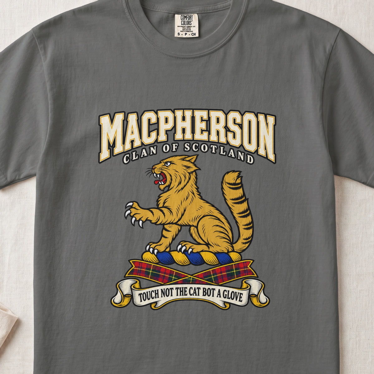MacPherson graphic T-shirt in Pepper gray, front flat lay showing varsity lettering and seated gold wildcat with black stripes, raised paw and upright tail.