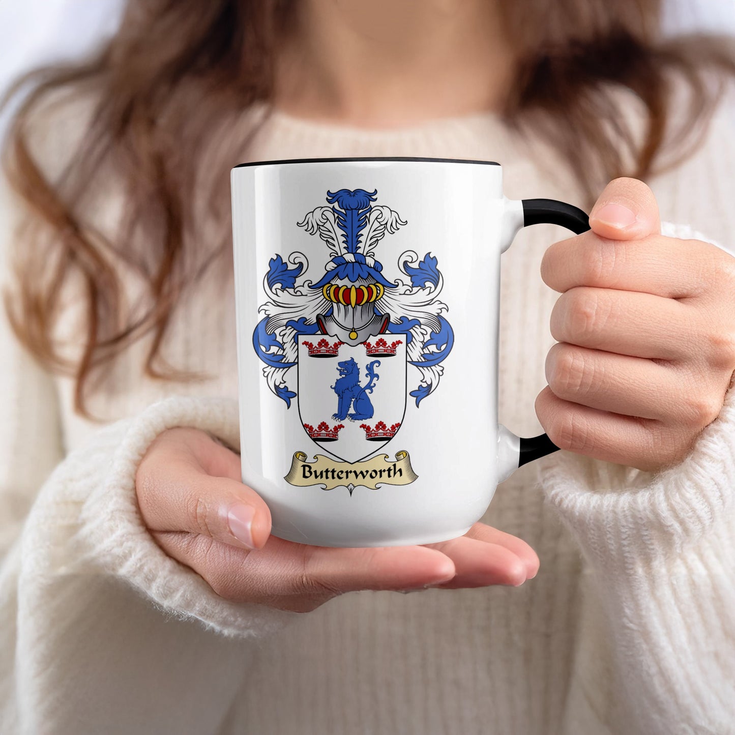 White mug with black rim displaying the Butterworth family crest.
