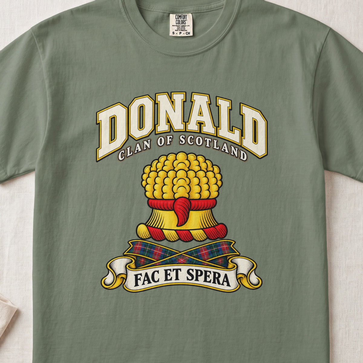 Donald Scottish clan T-shirt in Moss, front view with a gold sheaf of wheat and motto banner.