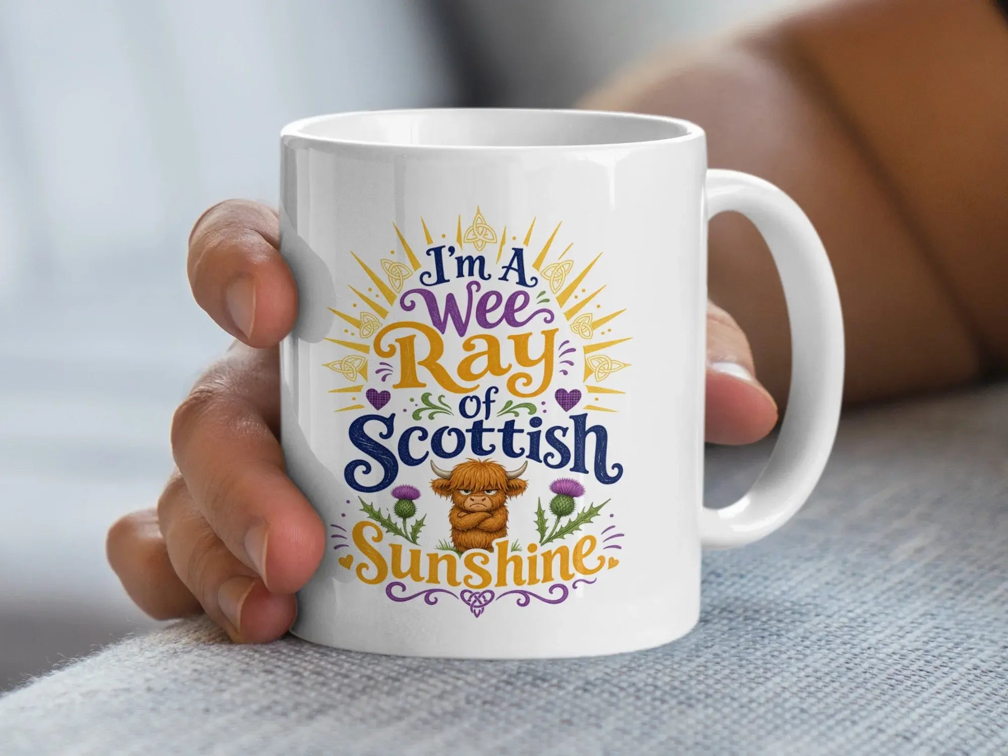 White mug with "I'm a wee Ray of Scottish Sunshine" text and a Highland cow.