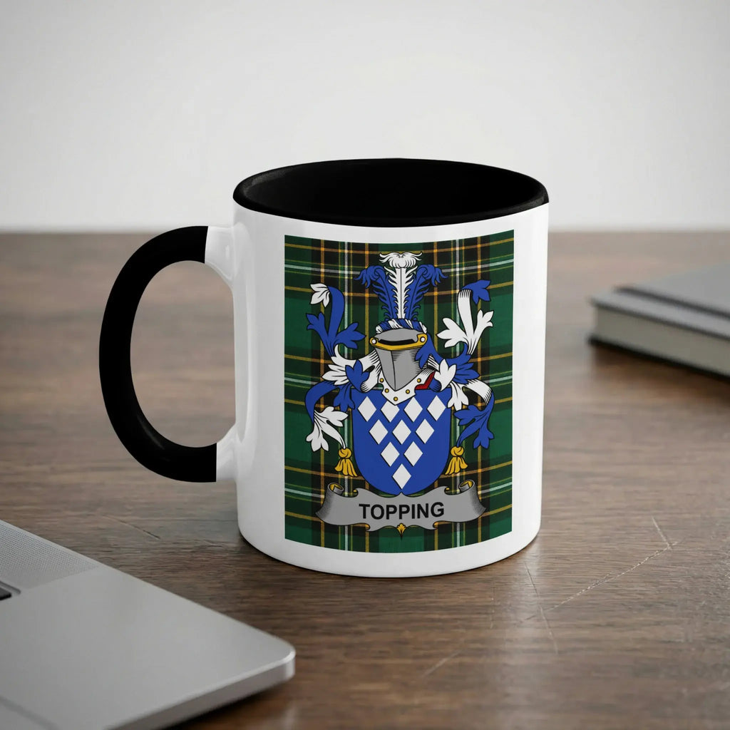 White mug with black handle featuring the Topping family crest on a tartan background.