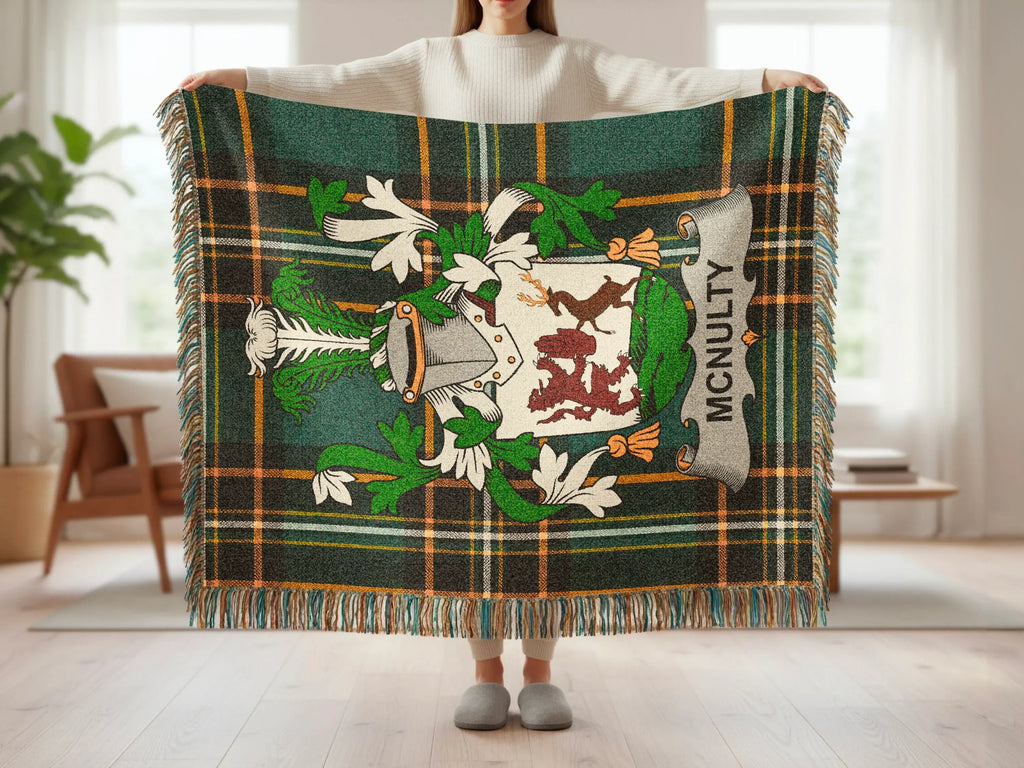 McNulty tartan blanket with coat of arms, held by person.