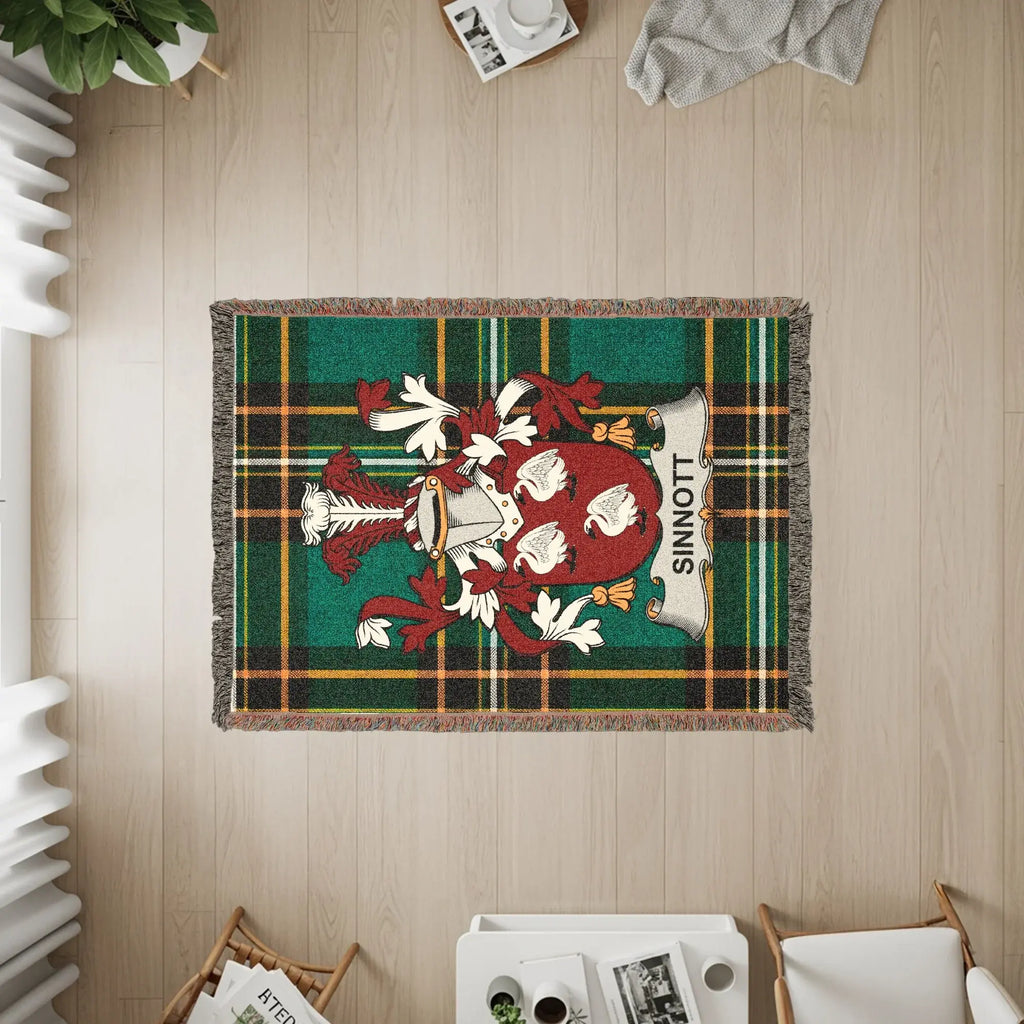 Tapestry rug with green plaid and SINNOTT family crest.