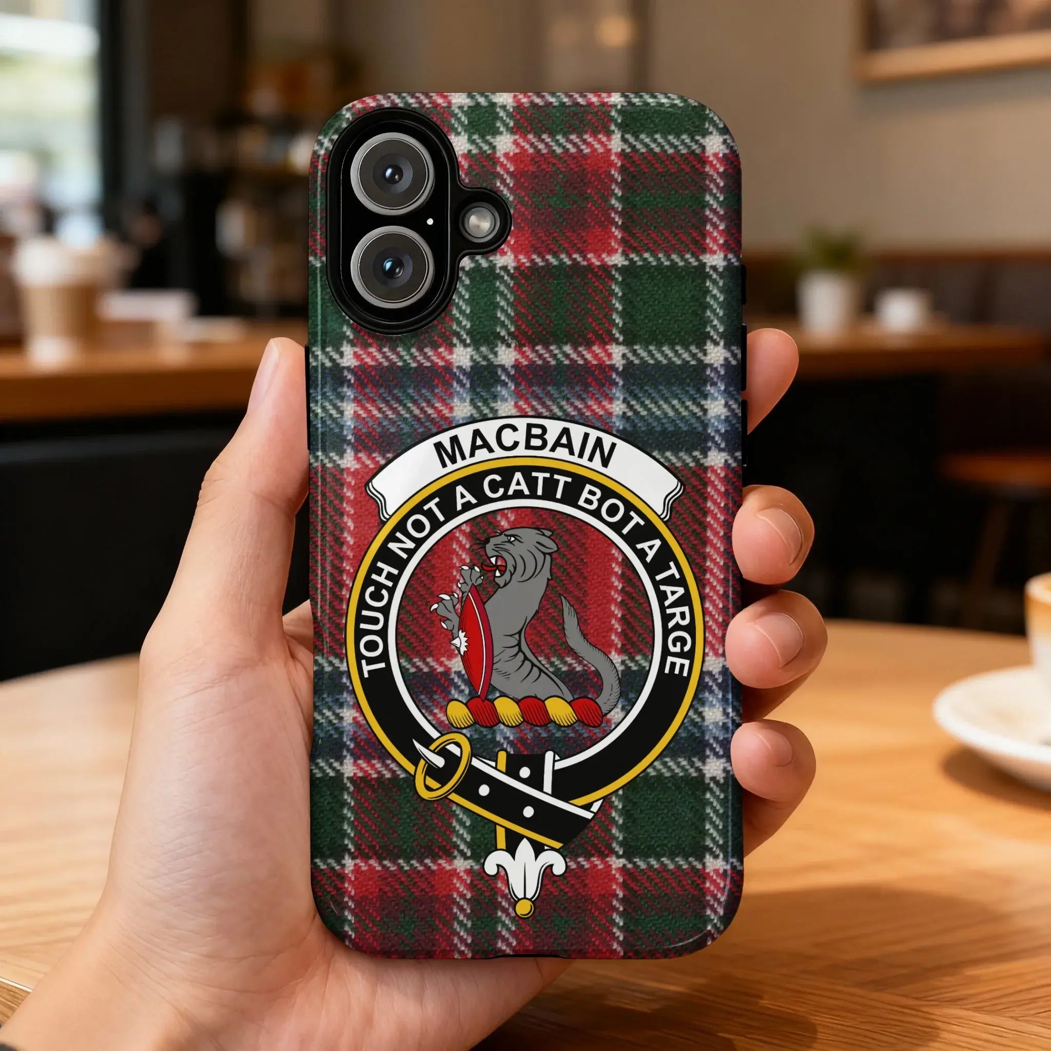 Clan MacBain crest phone case — iPhone fit shown, edge-to-edge tartan print with port cutouts