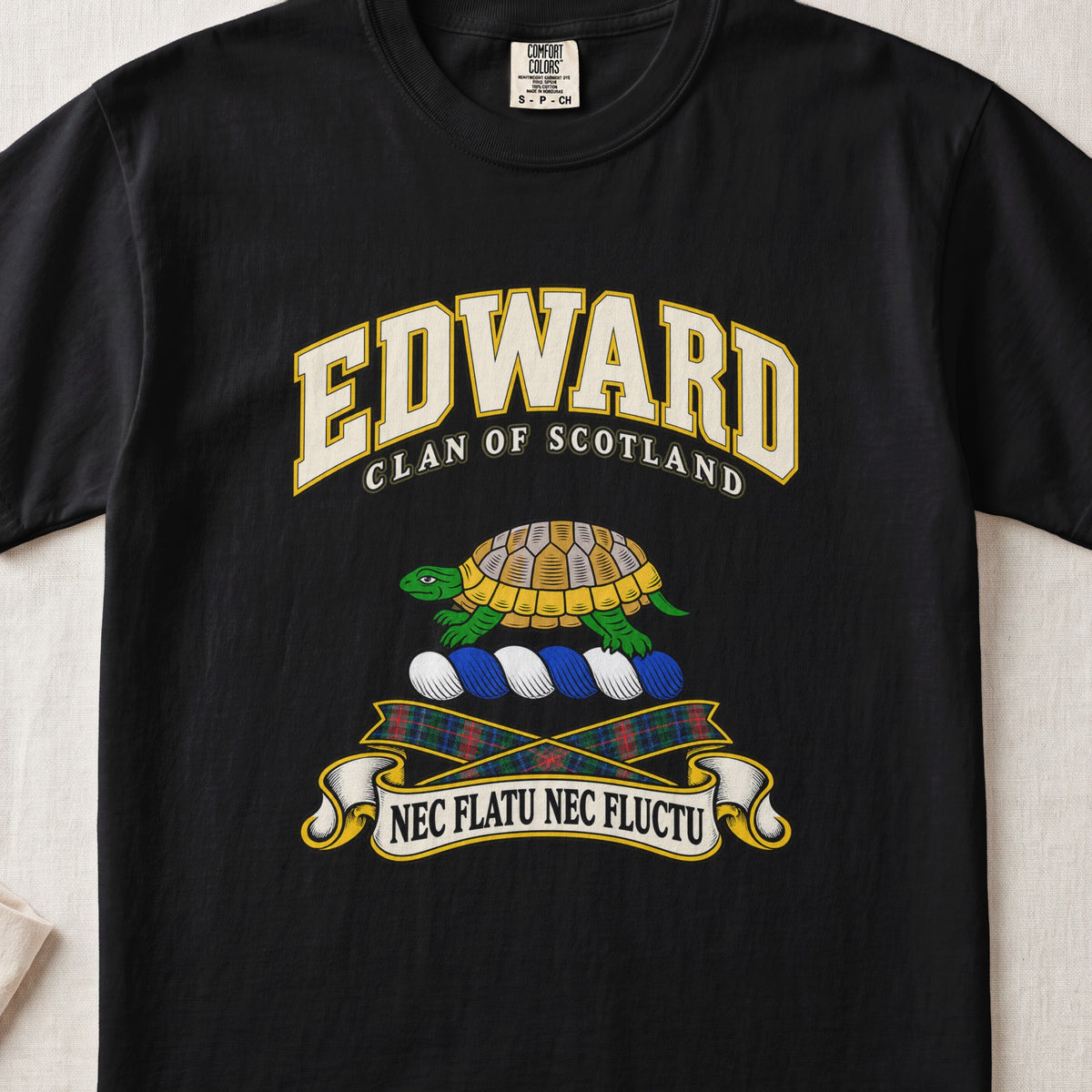 Edward Scottish clan T-shirt in Black, front view with a green and gold tortoise and motto design.