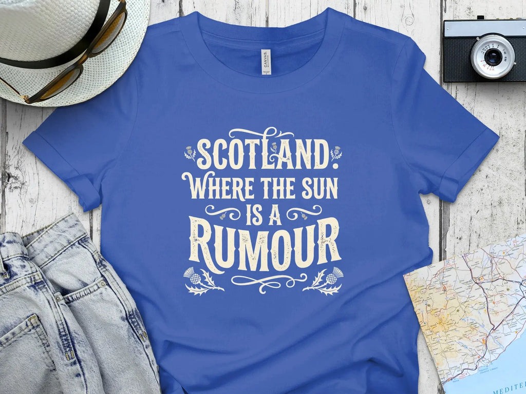 Blue t-shirt with "Scotland: Where the Sun is a Rumour" text.